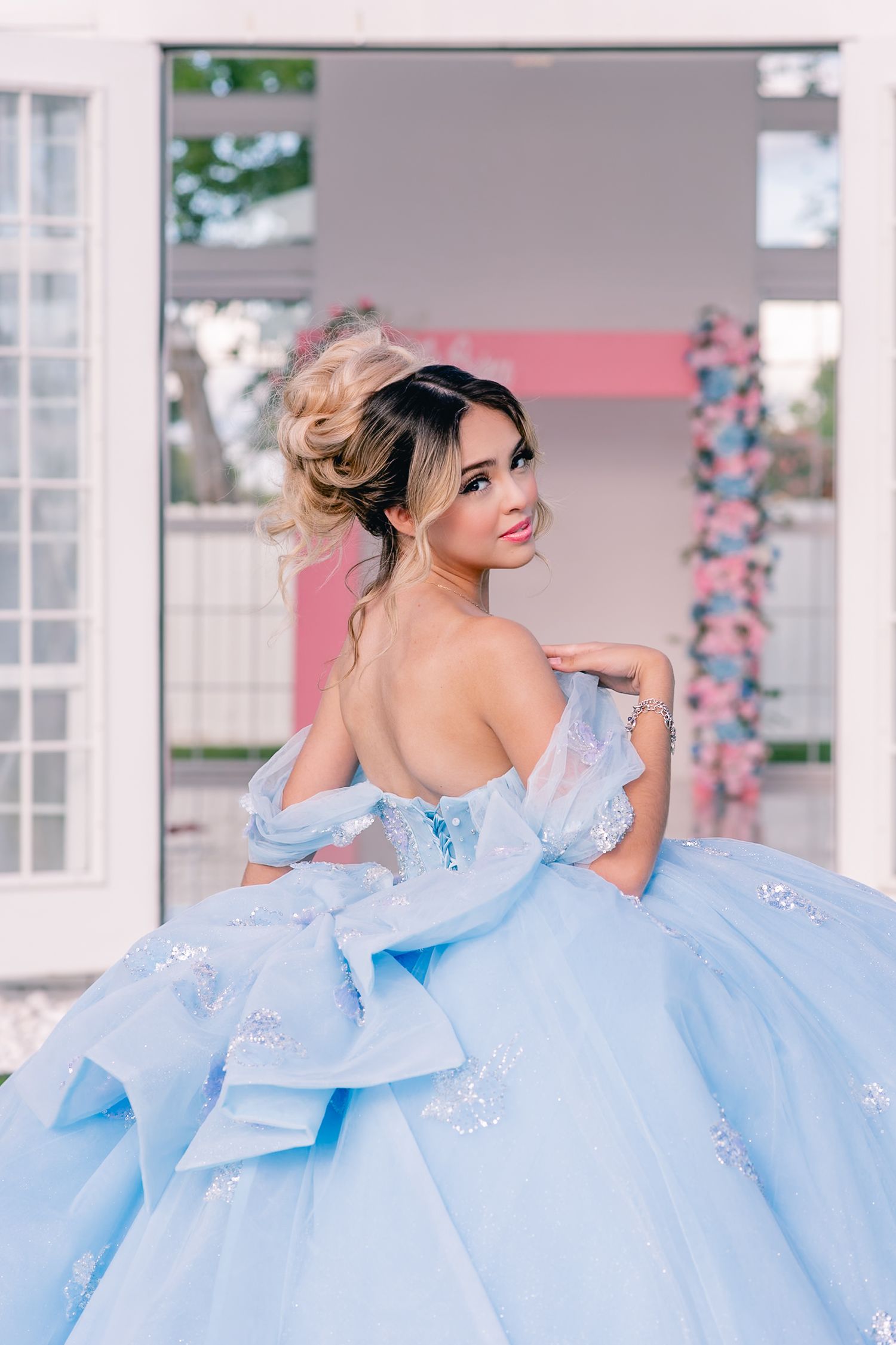 A luxurious ice blue princess gown with sparkly details photographed in an elegant indoor setting.