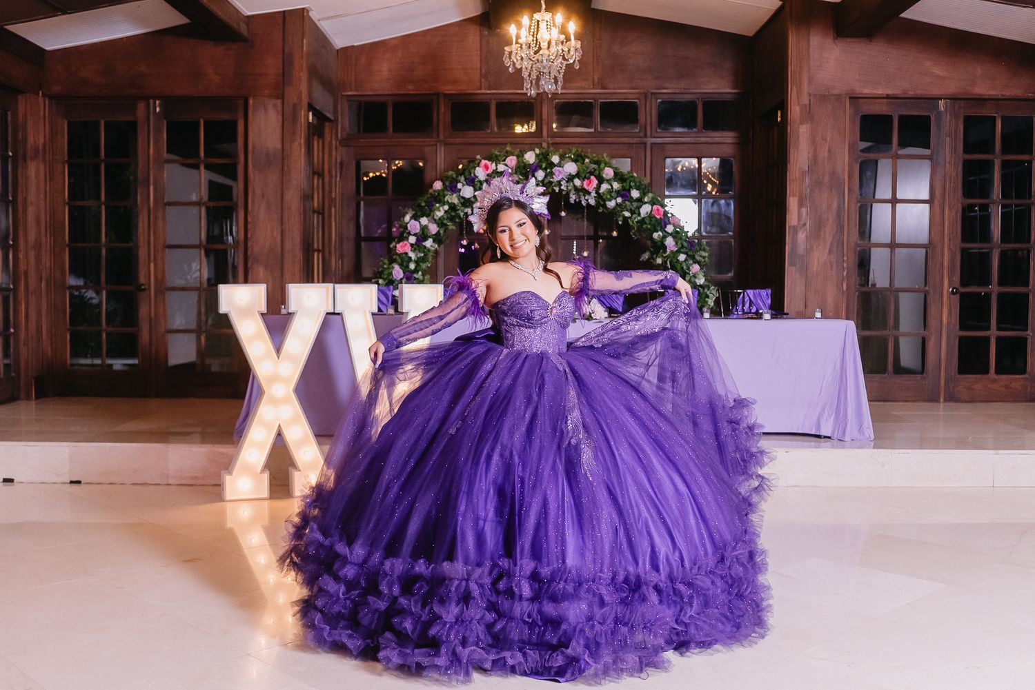 Stunning purple ballgown dress with layers of tulle photographed in an elegant ballroom setting.