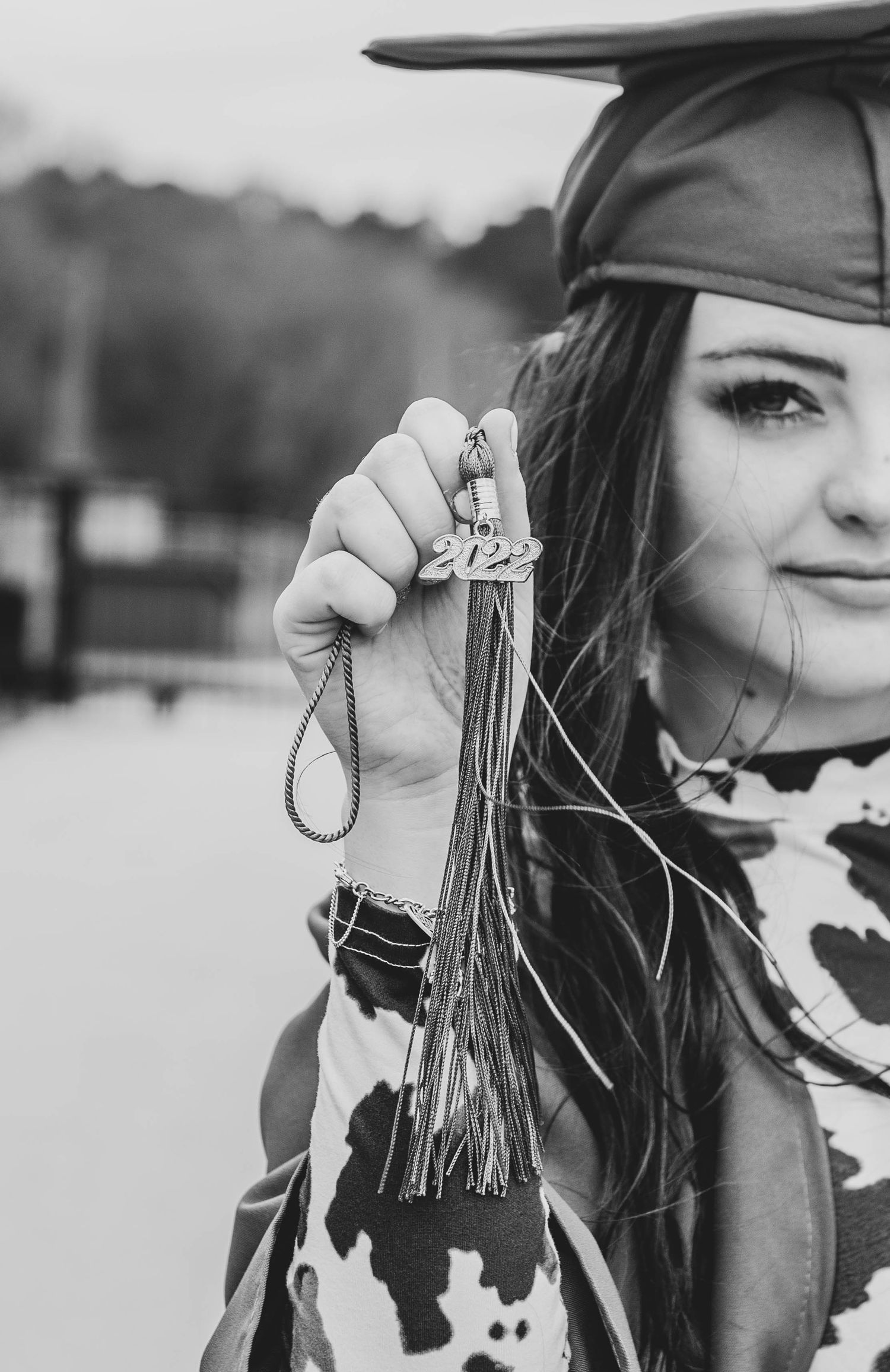 A graduation photo showing a tassel and cap against a blurred background.