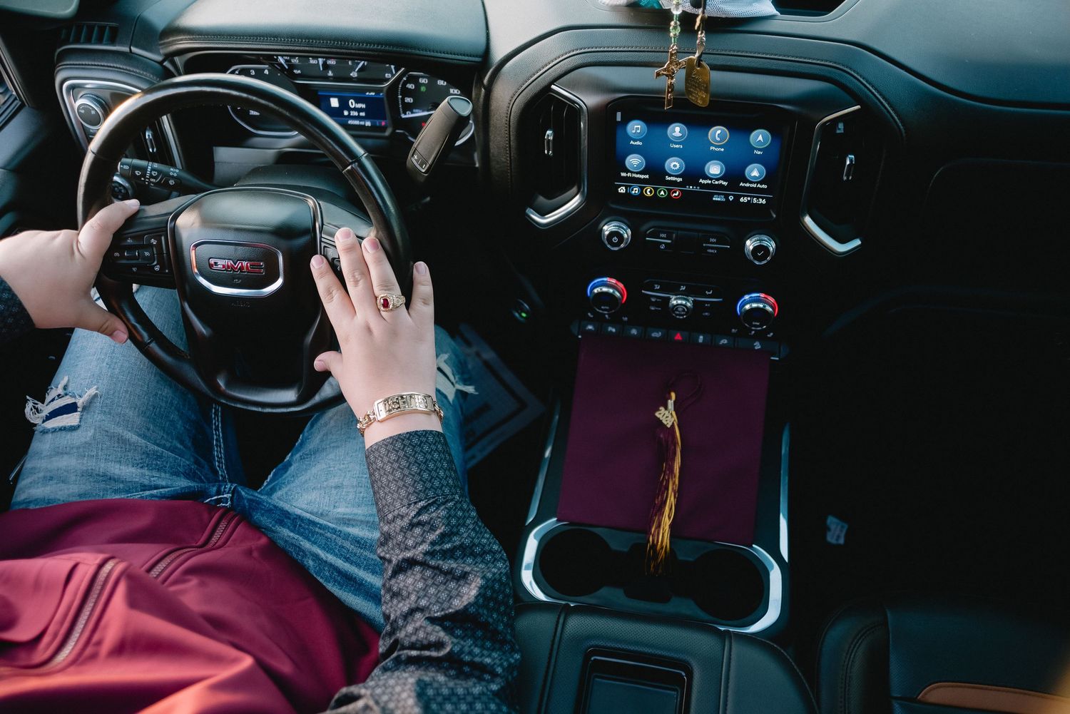 Interior view of modern vehicle dashboard showing digital display and steering wheel controls.
