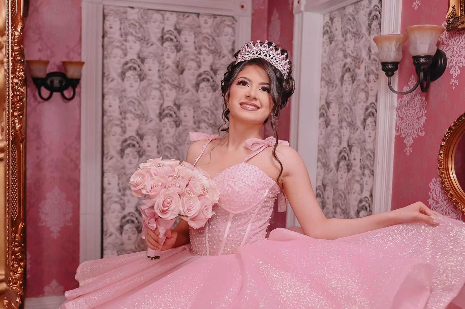 Elegant pink-themed photoshoot setting with ornate gold-framed mirrors and vintage decor.