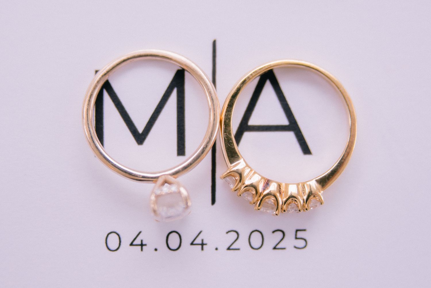 Gold wedding rings and date display on light background showing 04.04.2023.