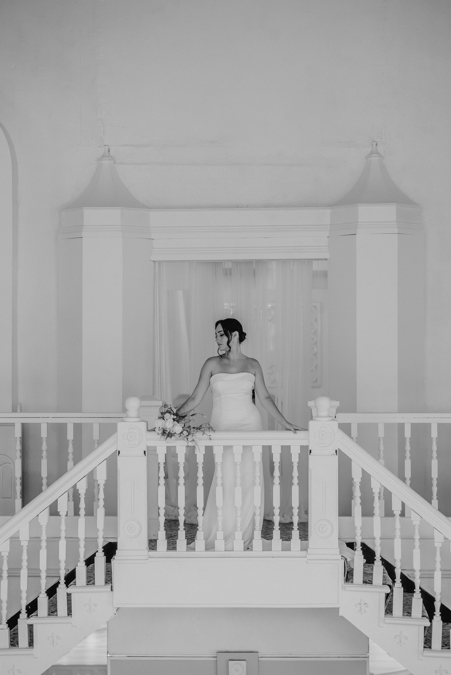 Black and white architectural detail of white balustrades and columns in an elegant venue.