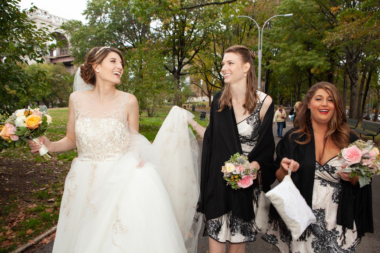 Wedding celebration scene outdoors with flowing white dress and flowers.