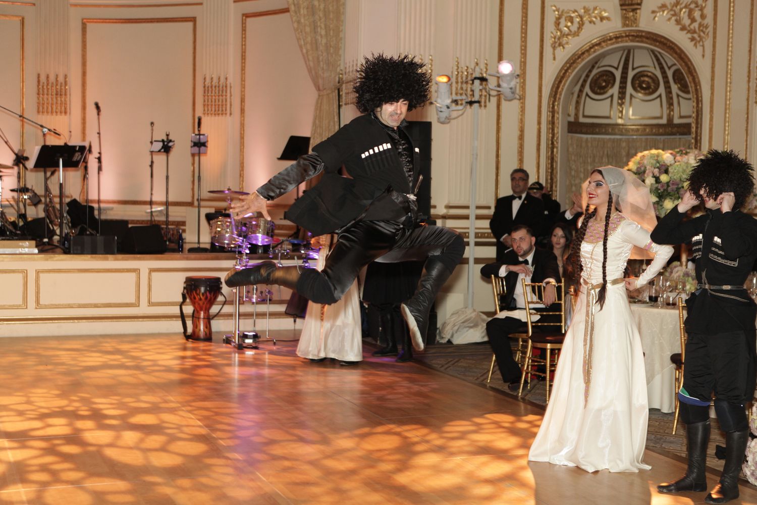Elegant ballroom decorated for a wedding reception with ornate architectural details.