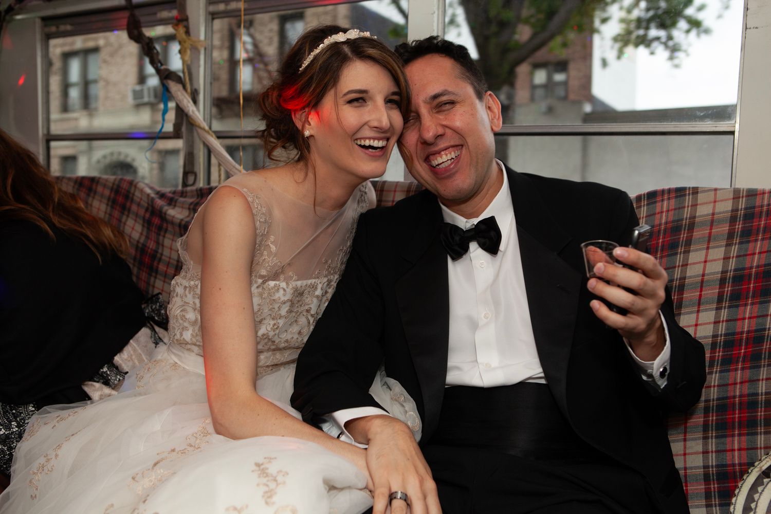 A couple sharing a happy moment outdoors during their wedding celebration.