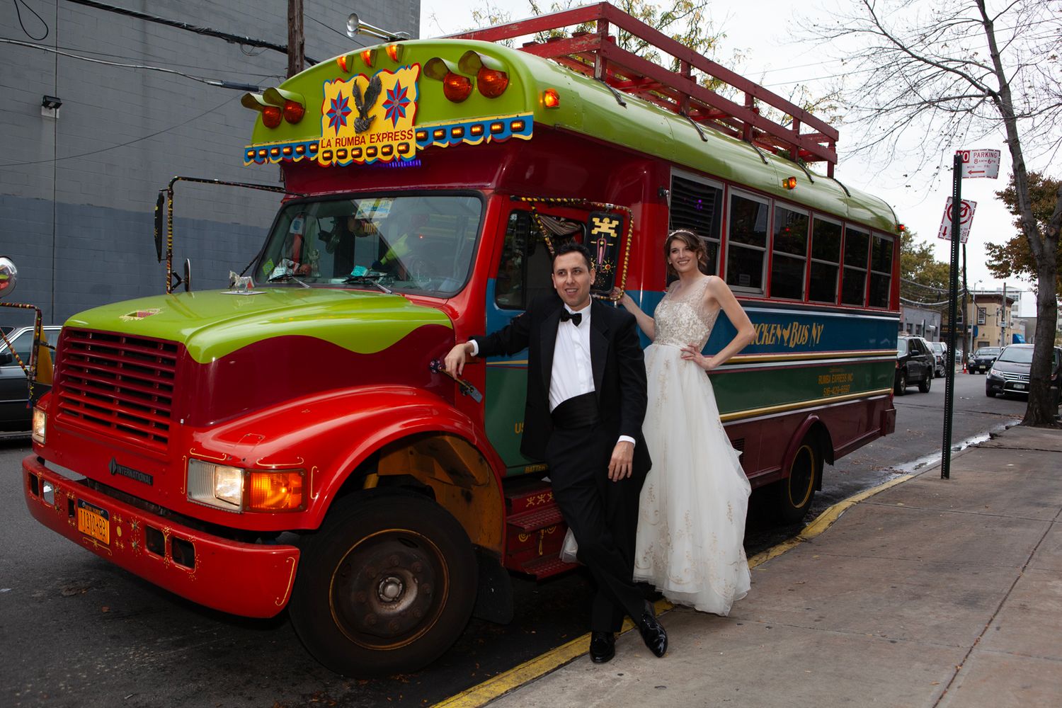 Colorful party buses lined up outside for wedding transportation.