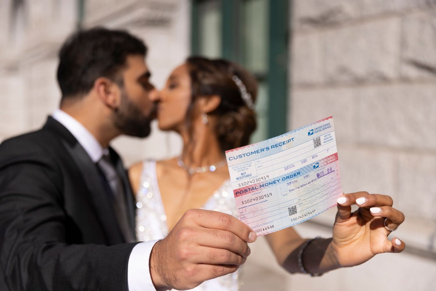 A sequence of photos showing a couple kissing and exchanging money in front of a white stone wall.