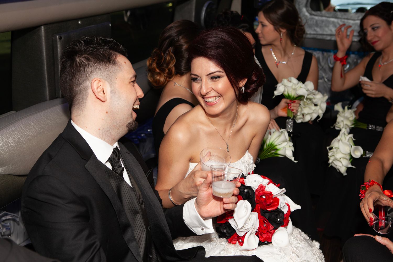 Wedding celebration scene with cake cutting at an indoor reception.