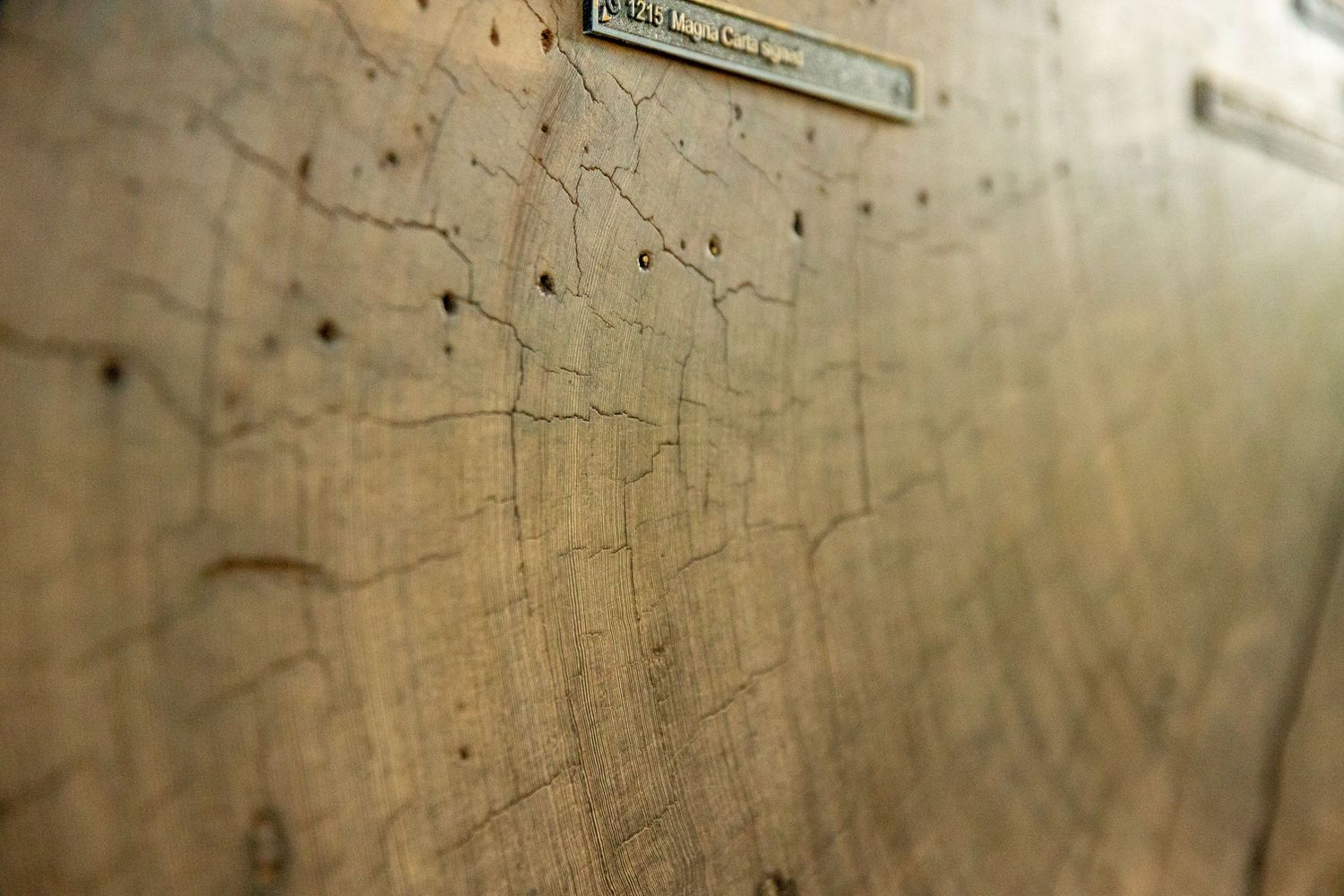 Close-up view of an old weathered map showing faint lines and markings with shallow depth of field.