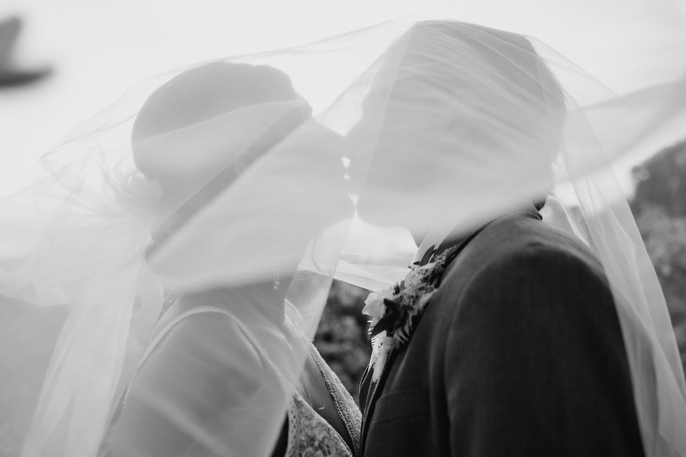 A series of romantic black and white photos showing intimate moments at a wedding celebration.