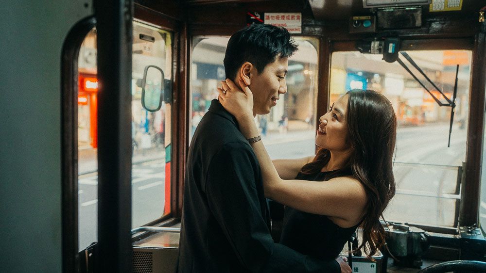 A quiet moment between a couple aboard a Hong Kong tram.