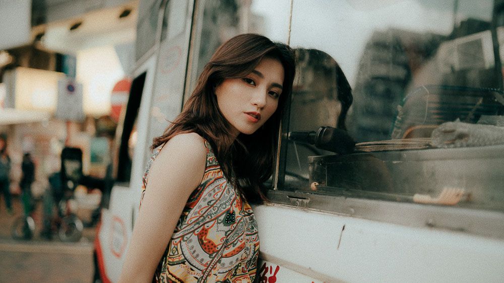 Urban fashion portraits on city street with natural lighting and modern architecture.