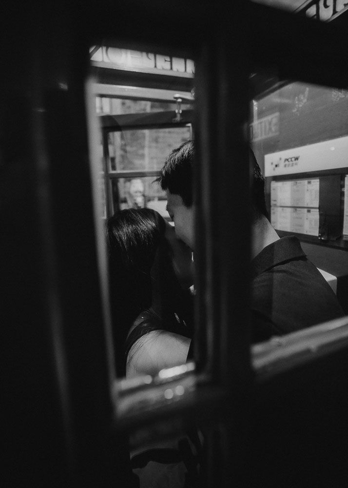 Black and white photo montage showing silhouettes through windows of a moving train.