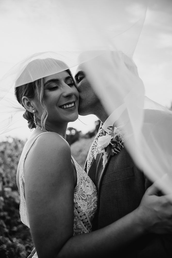 Black and white wedding portraits showing tender moments between the newlyweds.
