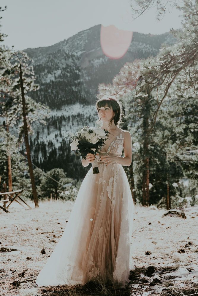 Ethereal bridal portraits against a scenic mountain landscape in soft sunlight.