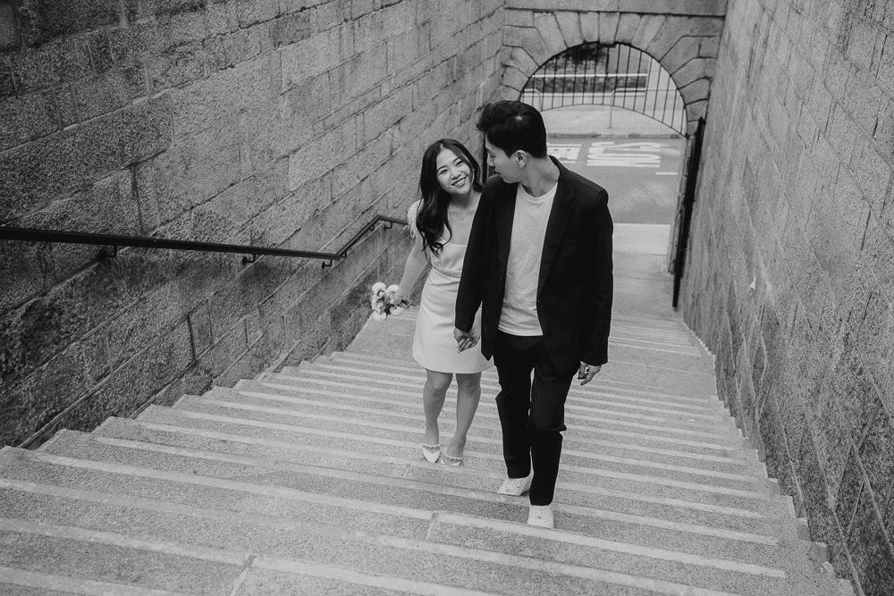 A sequence showing figures walking down stone steps in black and white photography.