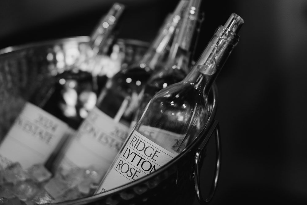Close-up of wine bottles chilling in an ice bucket, with one label partially visible.