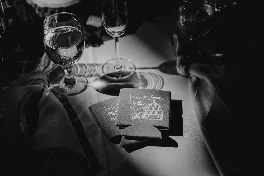 Wine glasses and place cards arranged on an elegant table setting in black and white.