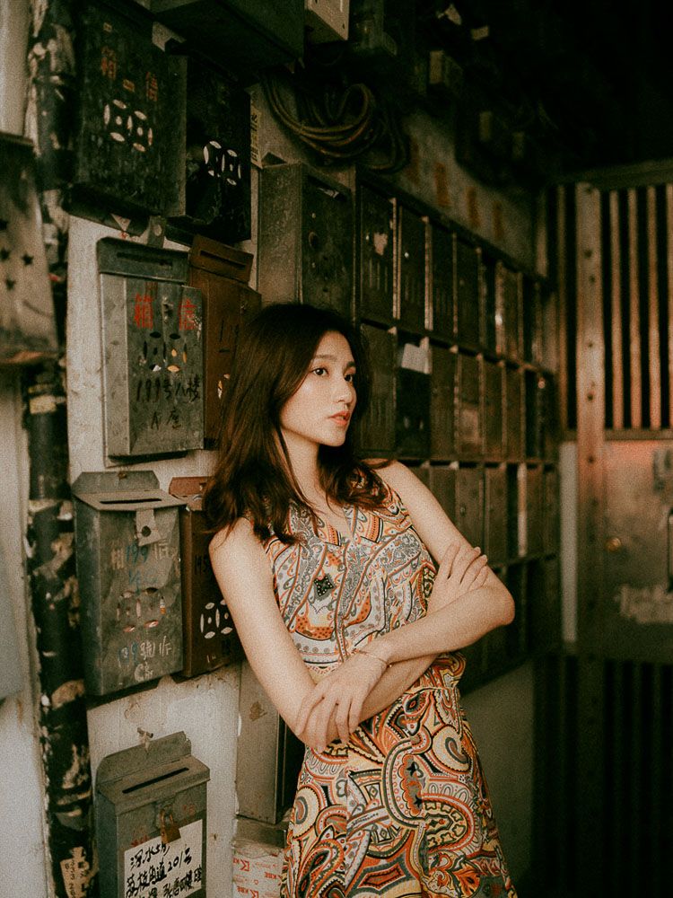 Dark and moody fashion photography in an industrial corridor with vintage aesthetics.
