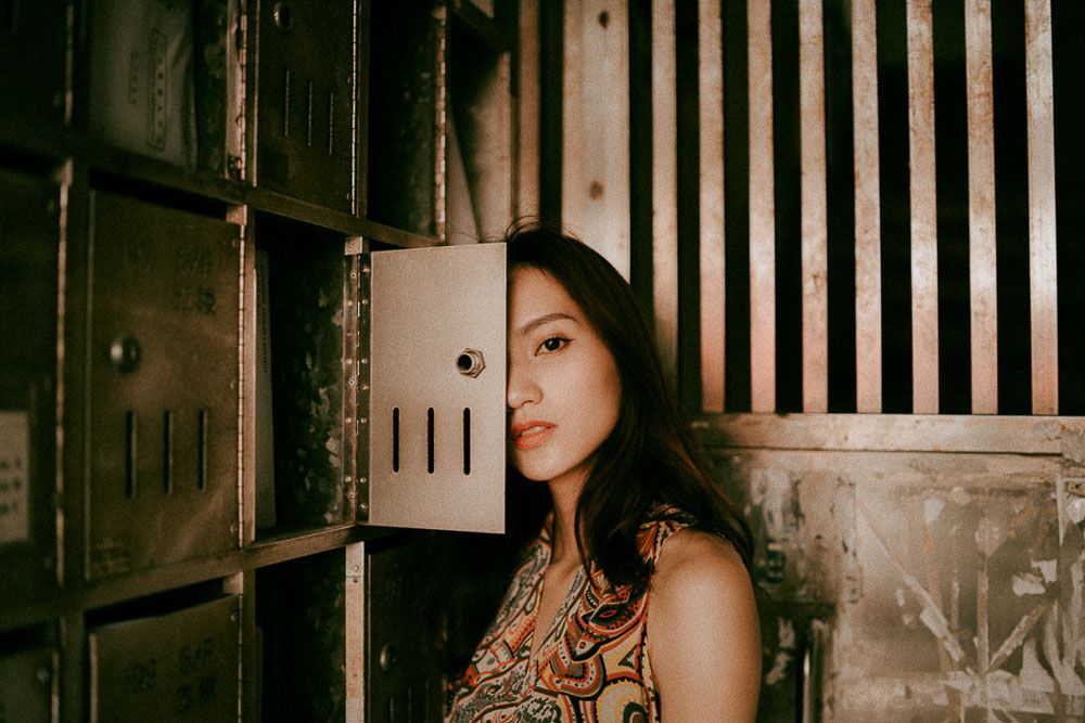 Artistic portrait series with wooden slat background and dramatic lighting.
