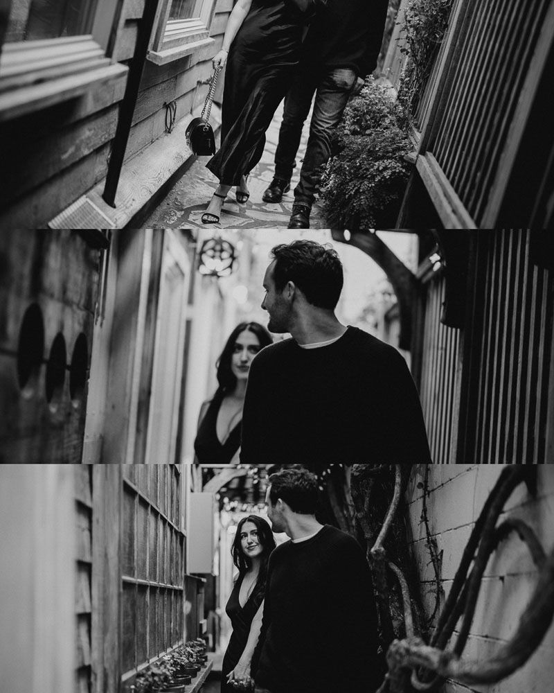 Black and white urban street scene with couple sharing an intimate moment against city backdrop.
