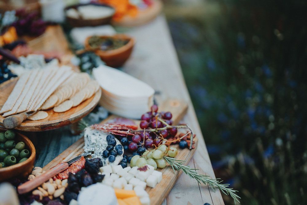 Gourmet cheese and charcuterie board with grapes and crackers arranged for entertaining.