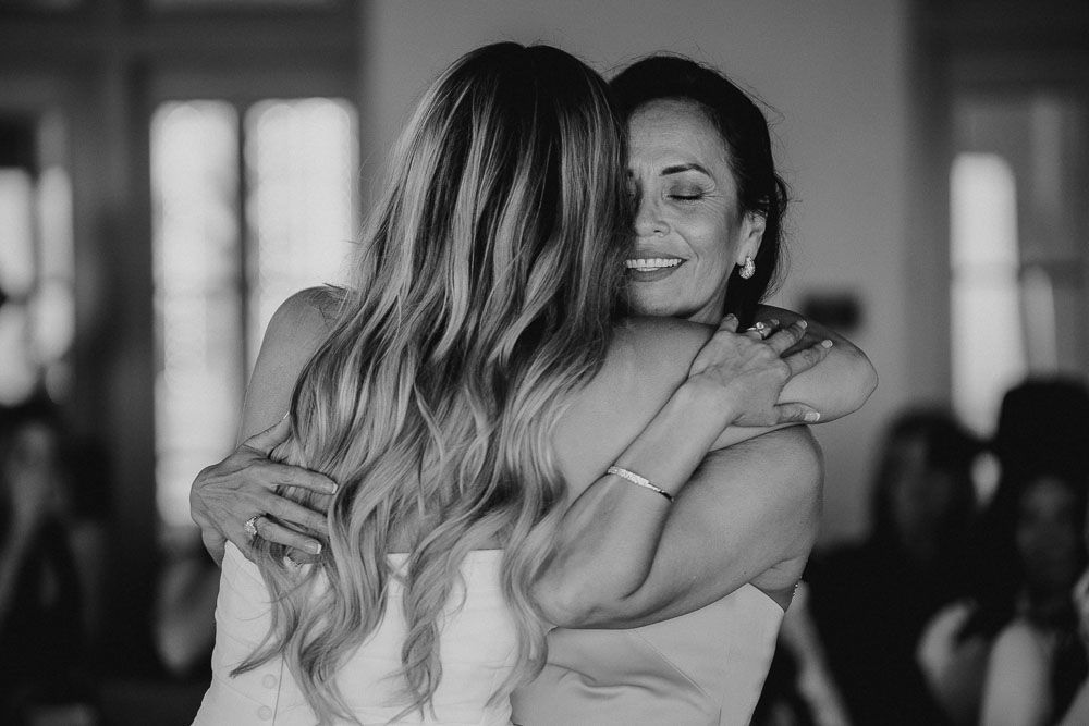 Emotional black and white candid moment during wedding celebration.