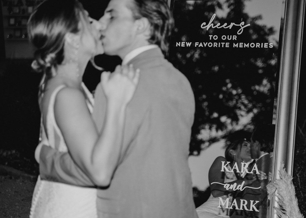 Wedding couple sharing romantic moments captured in atmospheric black and white photography.