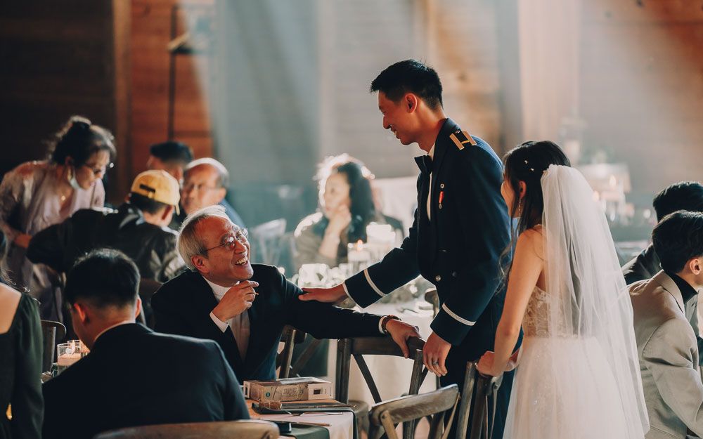 Couple greets reception guests during dinner service.