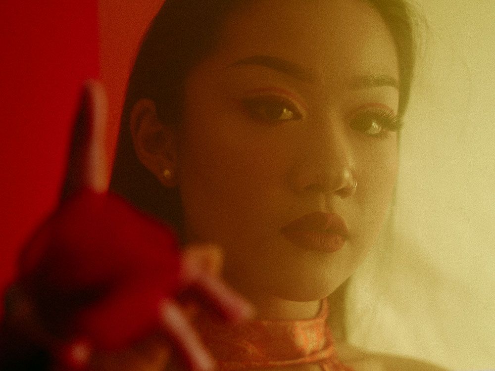 Close-up portrait series with dramatic warm lighting and red lipstick against soft backgrounds.