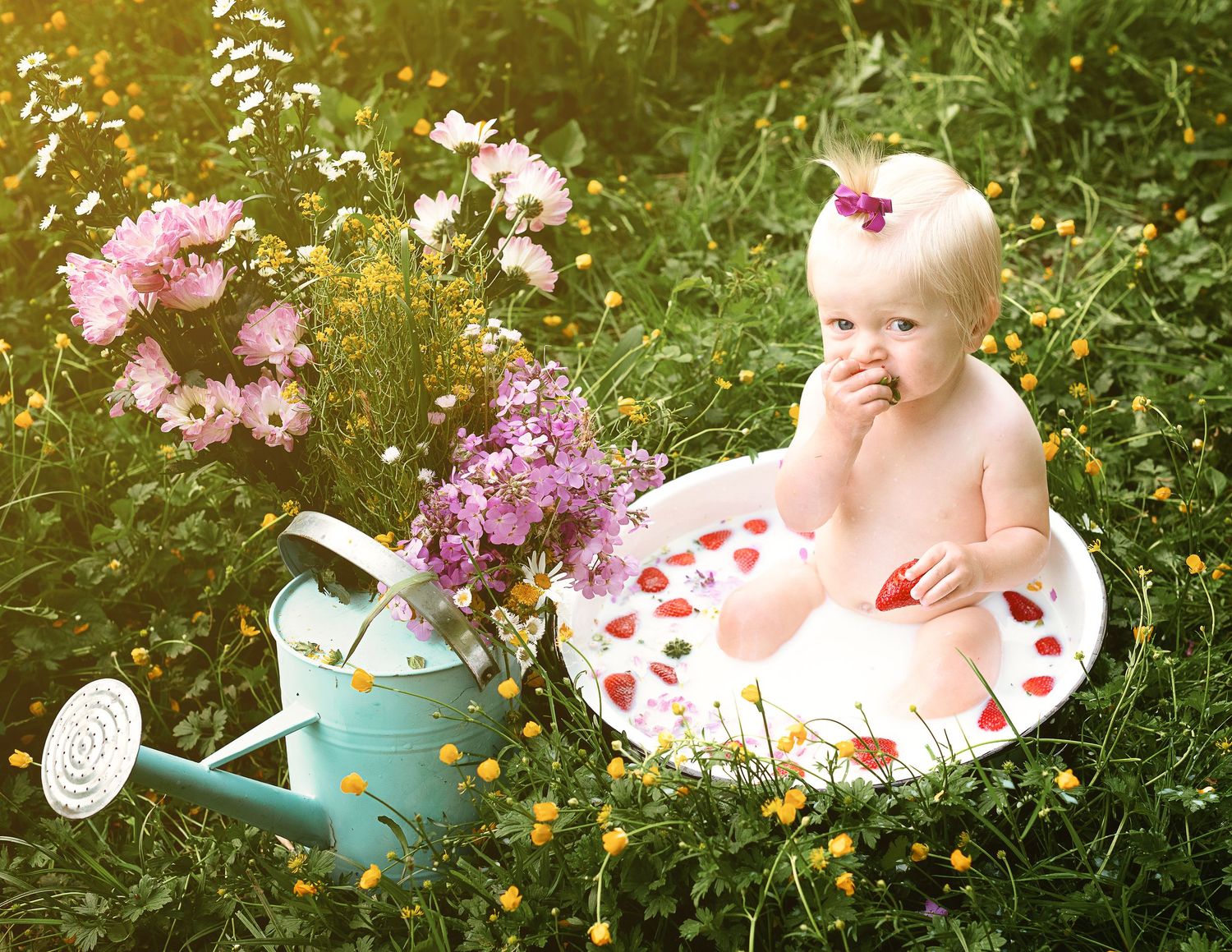 Whimsical garden photo session with vintage watering can and flowers.