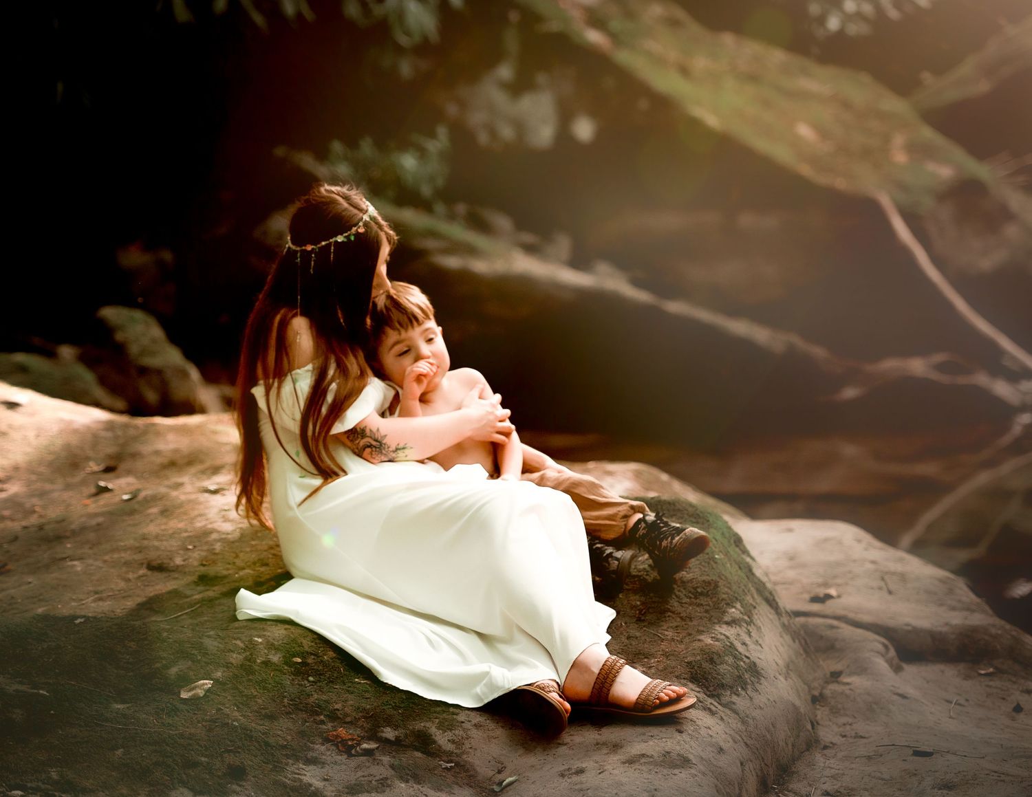 Artistic portrait session on natural rock formations in white flowing dress.