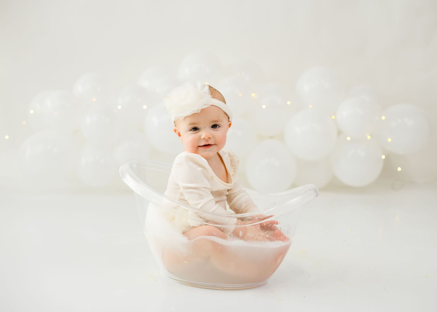 White minimalist photography setup with soft lighting and bubbles.