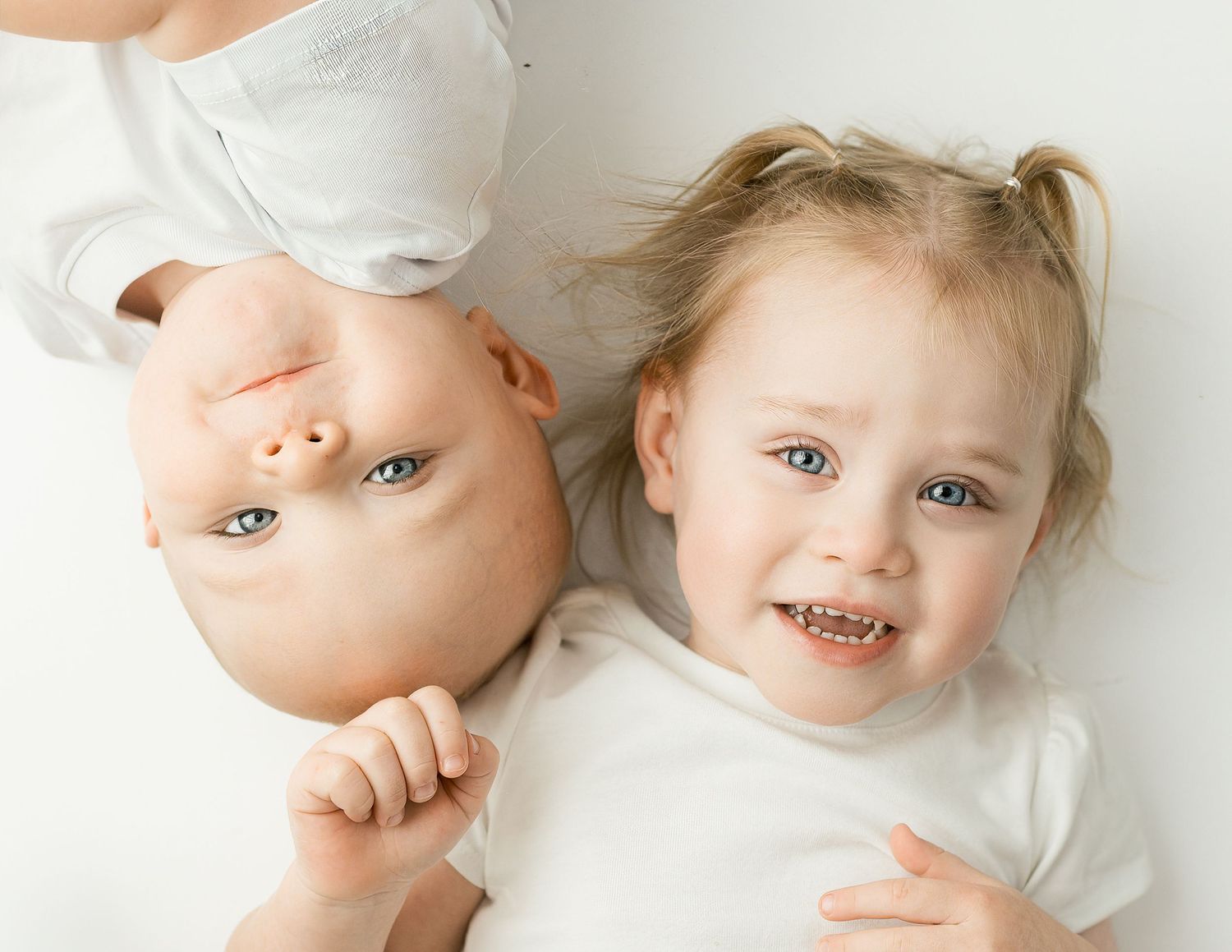 A series of close-up photos showing a baby in white clothing against a light background.