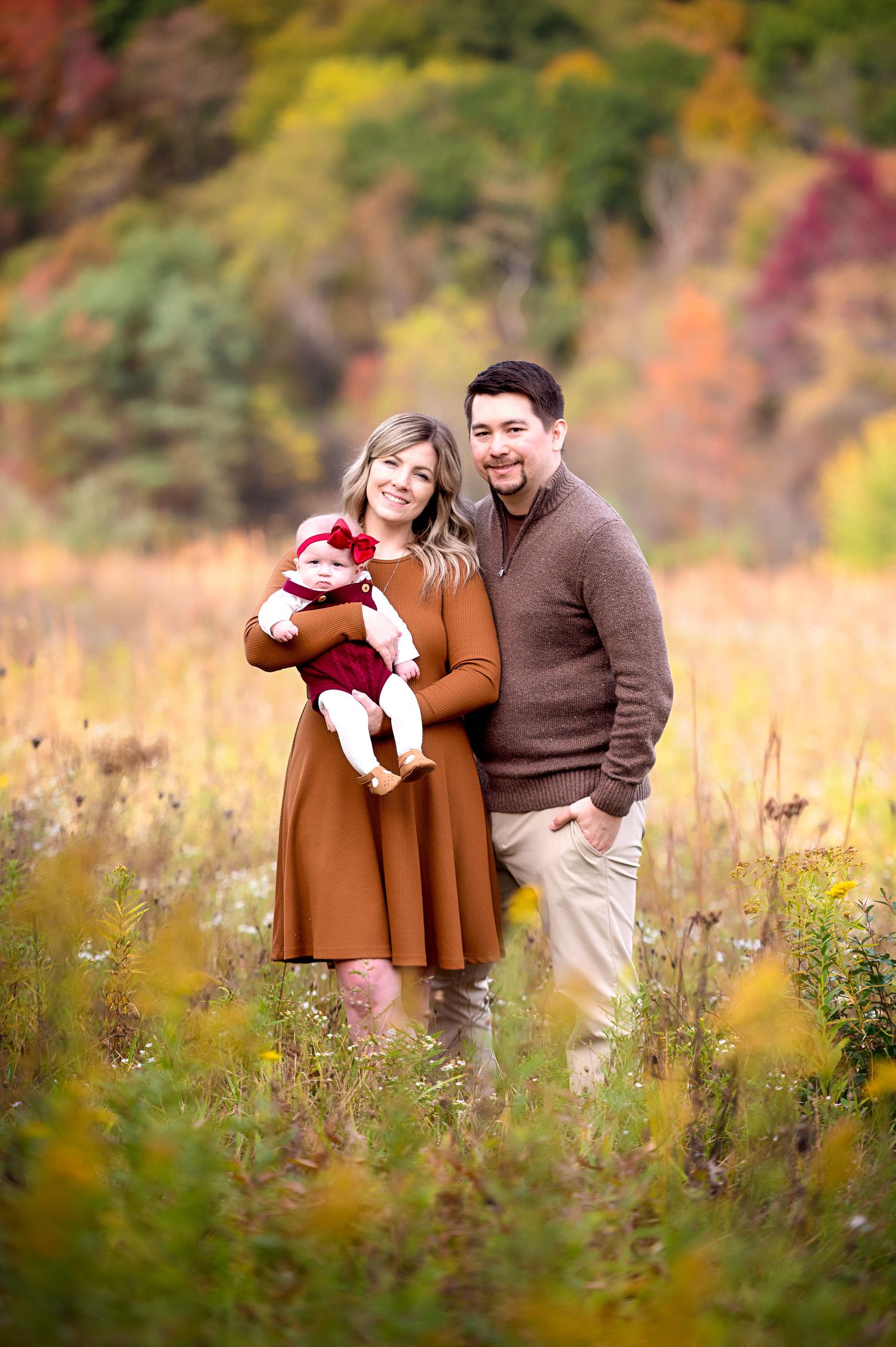 Romantic autumn photoshoot in a field of wildflowers with warm golden light.