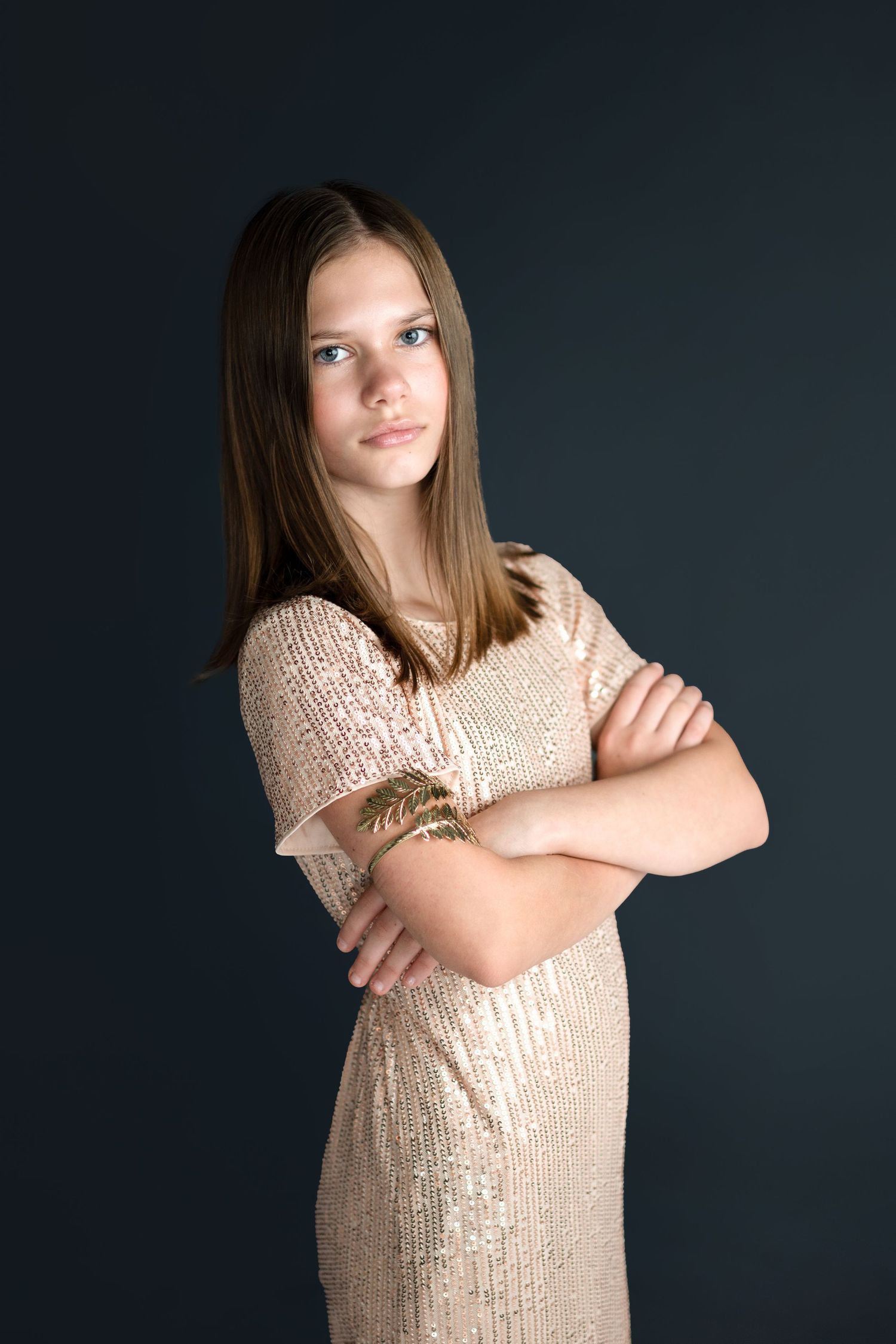 Portrait series in sparkly gold dress against dark background showing different poses.