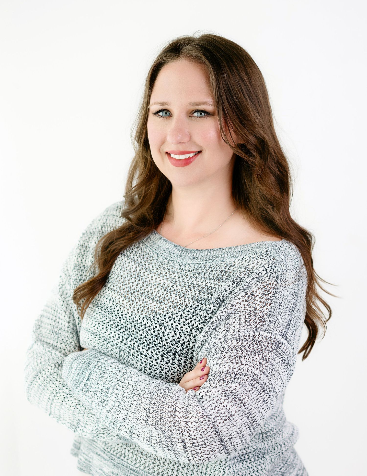 Portrait series of woman in cozy knit sweater against white background.