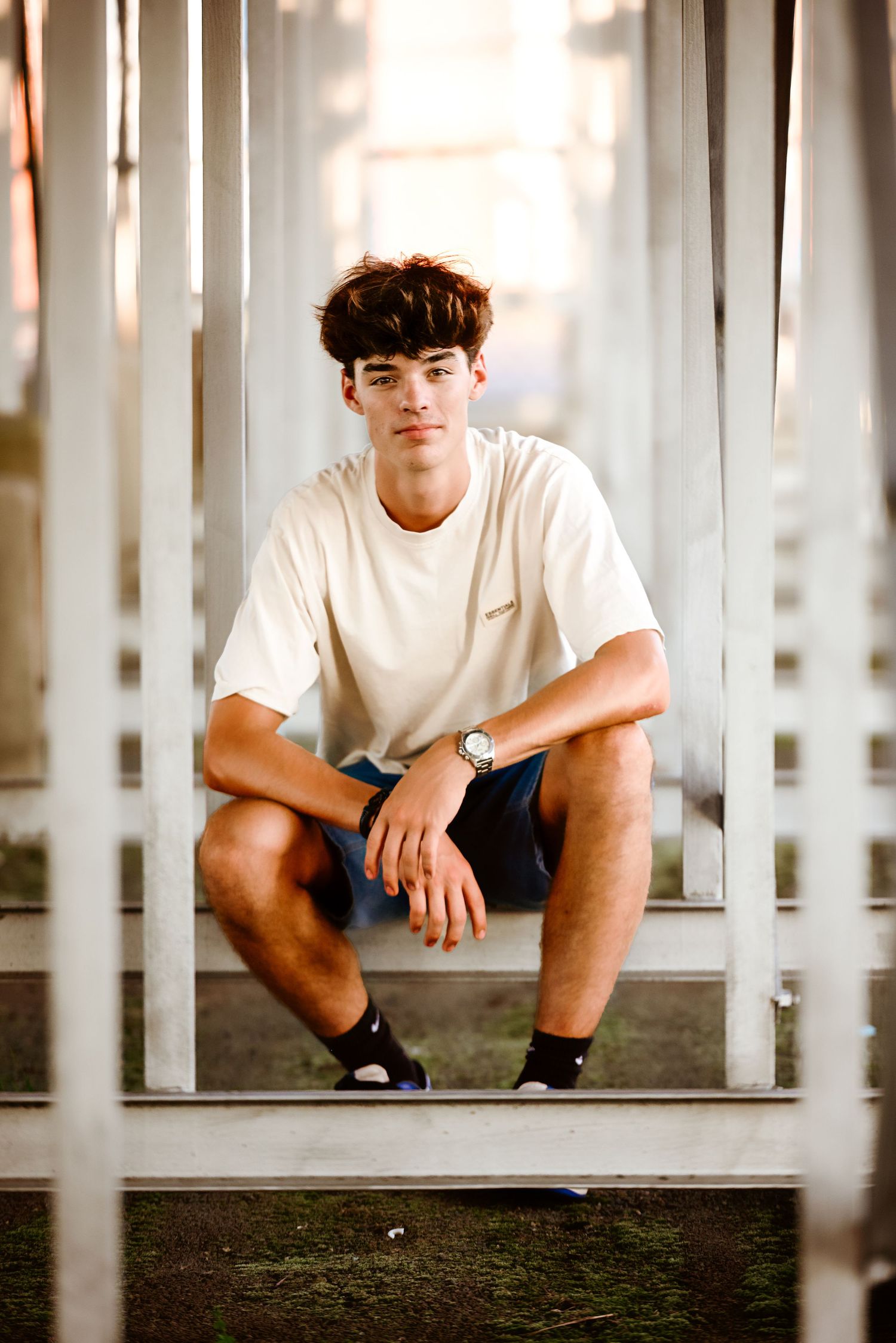 Casual portrait session under white architectural columns.