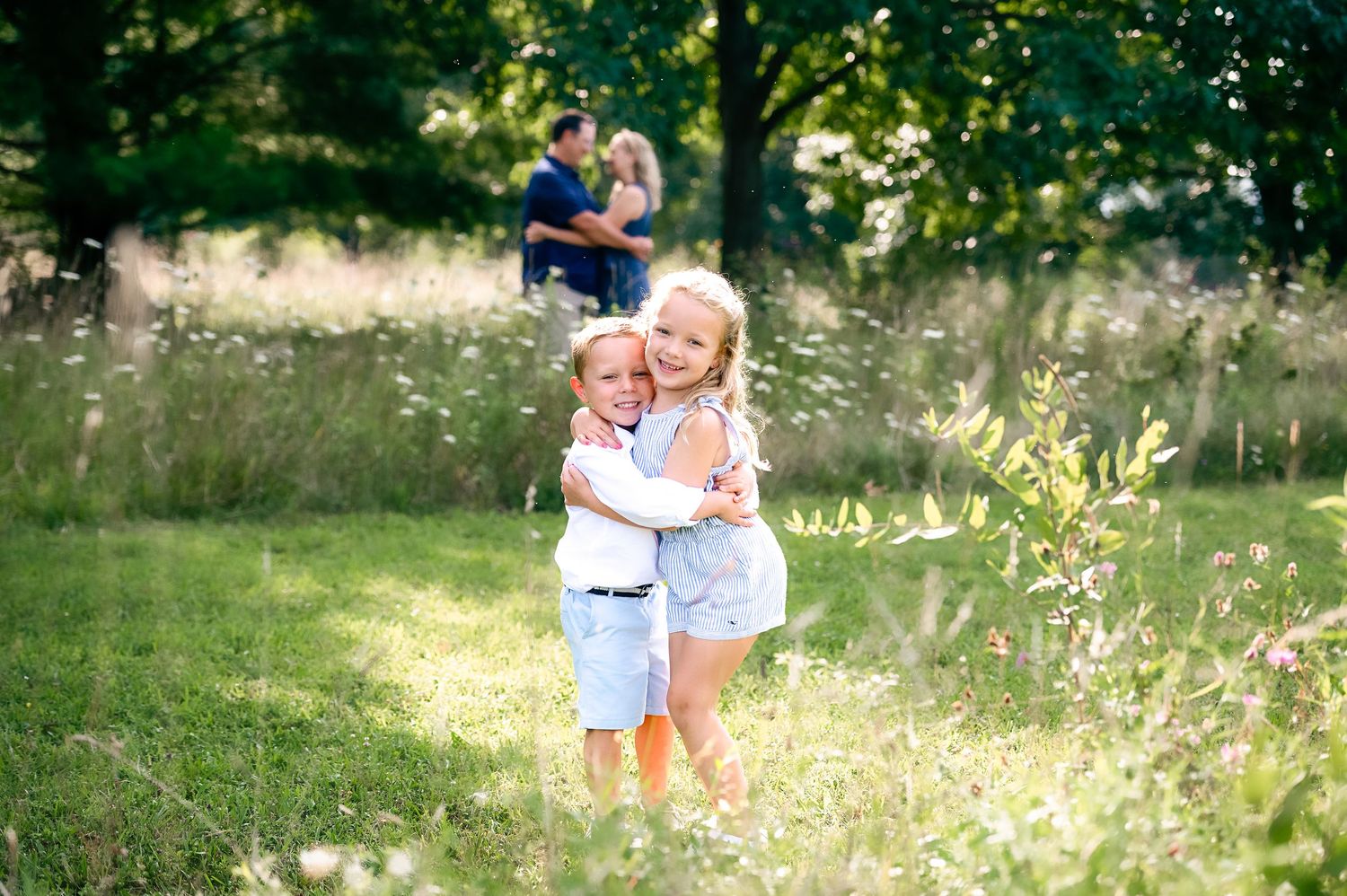 Joyful family interactions captured in blooming wildflower field.