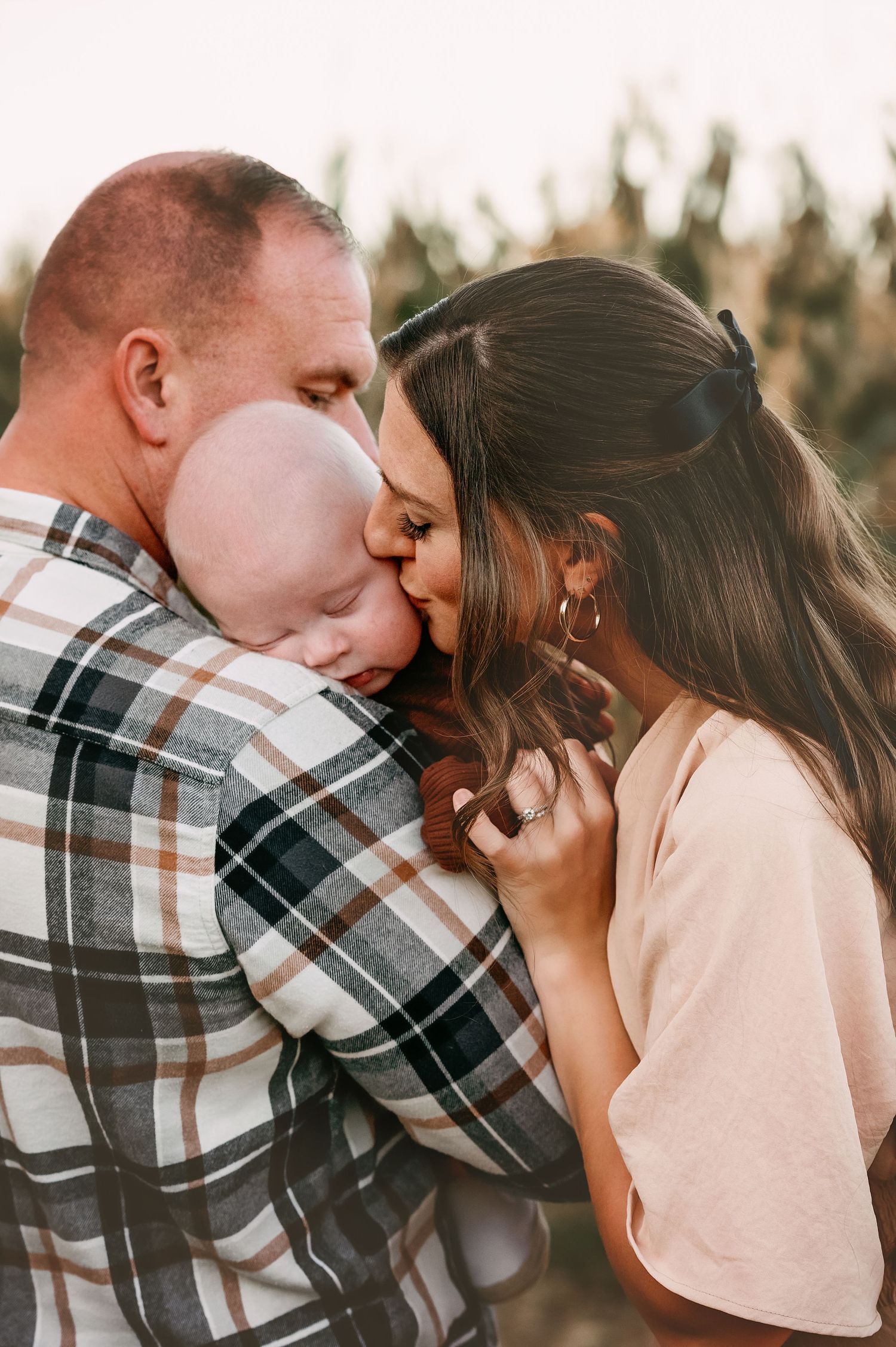 Intimate couple shares tender moment during golden hour photoshoot.