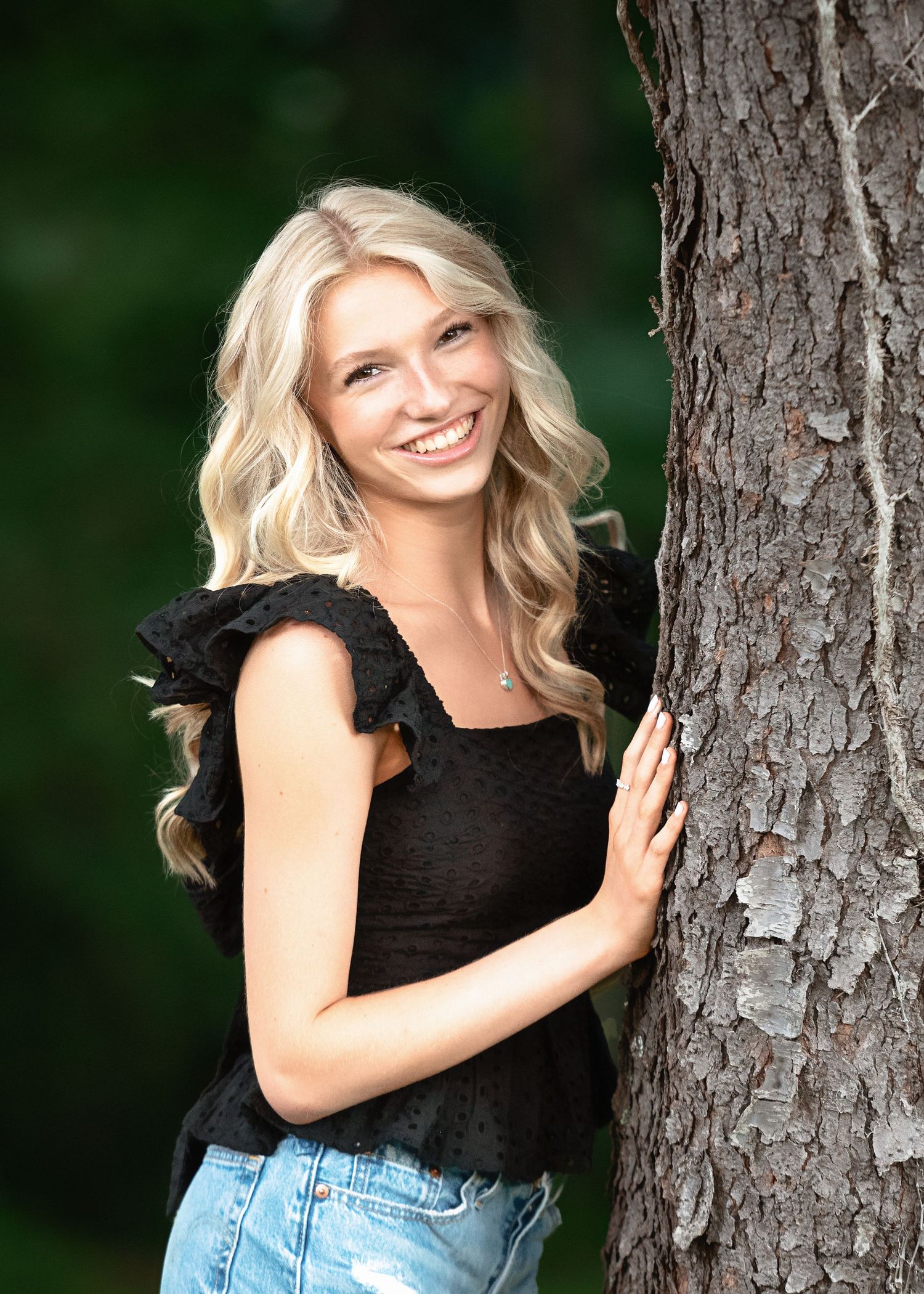 Natural portrait session against textured tree bark background.
