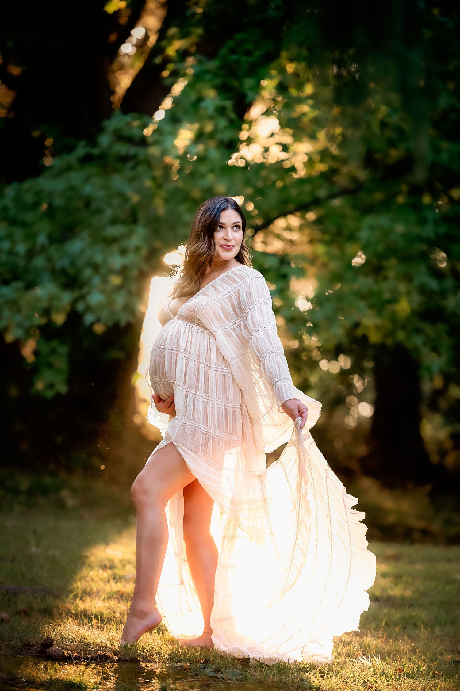 Ethereal backlit portrait session in a flowing white dress during golden hour.