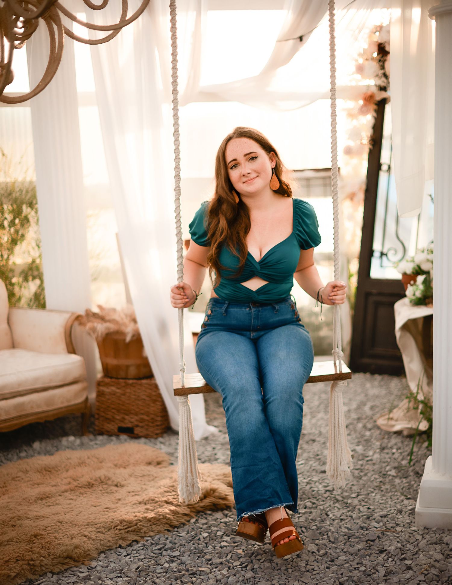 A rustic porch swing scene with white pillars and hanging rope details in warm lighting.