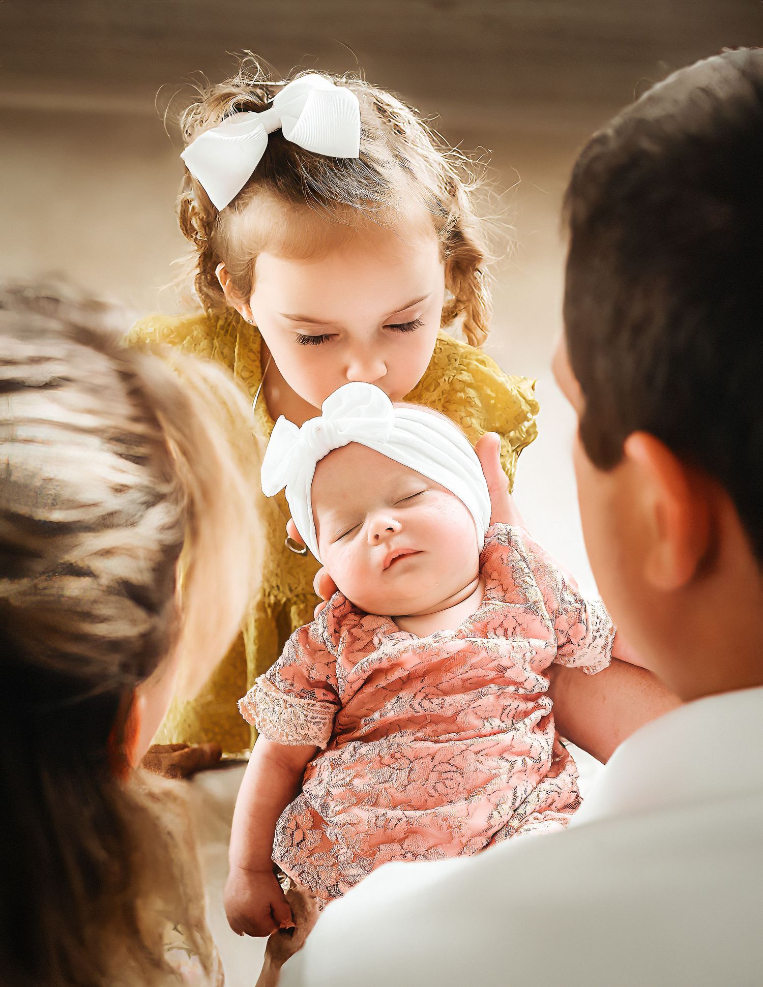 Candid family moments with baby in pink dress during sunset.