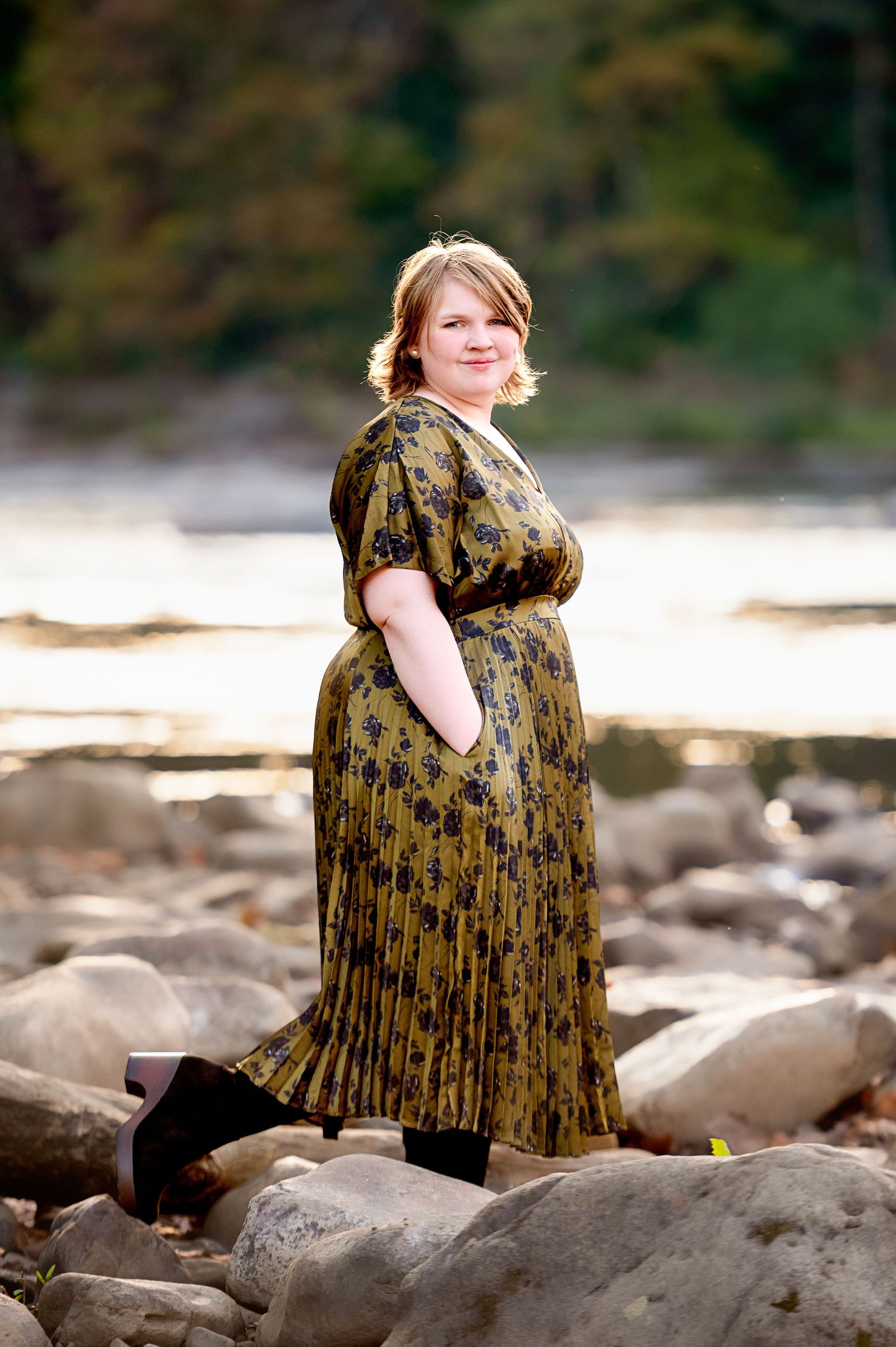 Artistic sequence of someone in a floral dress sitting on rocky terrain during a sunny day.