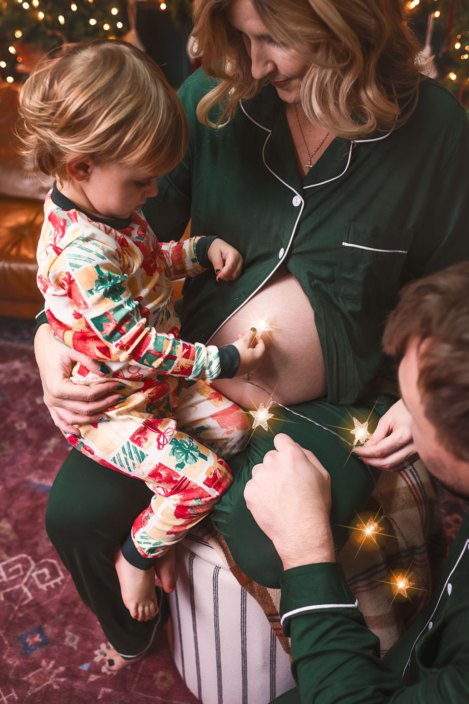 Family in matching holiday pajamas sharing intimate moment with sparklers.