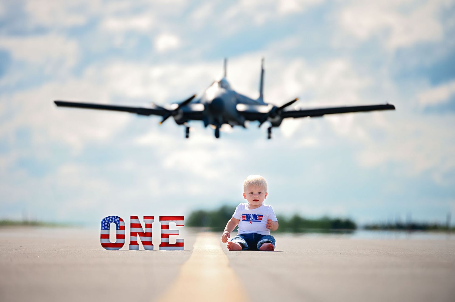 Vintage aircraft and aviation themed first birthday photo shoot on airfield.