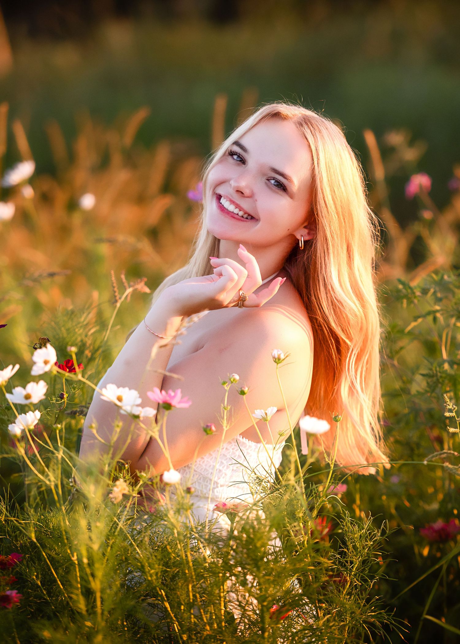 A dreamy portrait among wildflowers at golden hour with soft natural lighting.