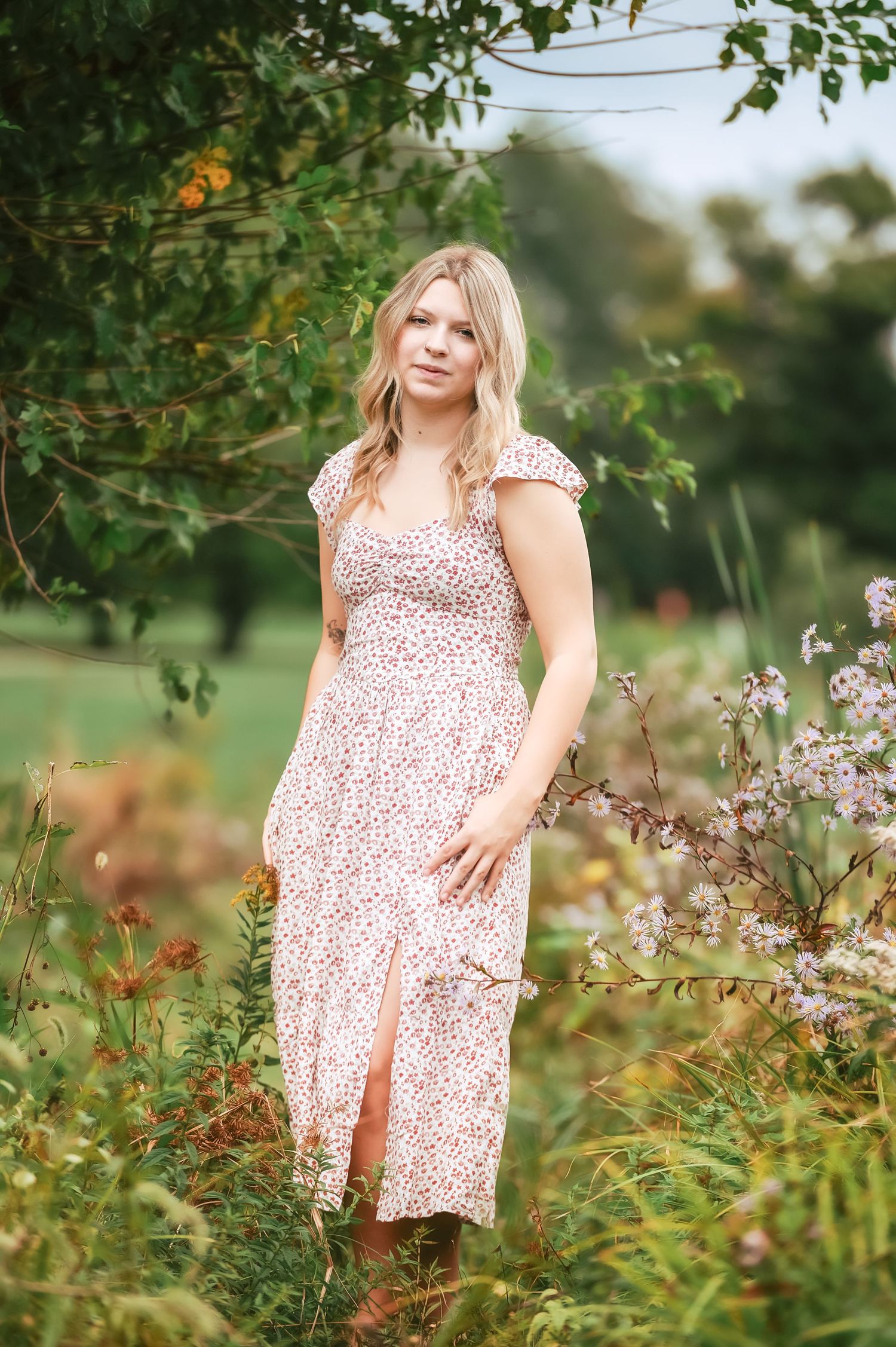 Summer garden portrait featuring floral dress and natural surroundings.